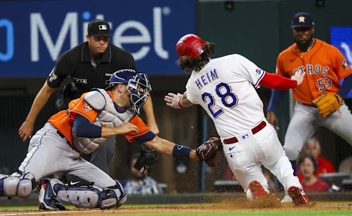 Apr 27, 2022; Arlington, Texas, USA; Houston Astros catcher Jason Castro (18) tags out Texas Rangers catcher Jonah Heim (28) at home plate during the second inning at Globe Life Field. Mandatory Credit: Kevin Jairaj-USA TODAY Sports